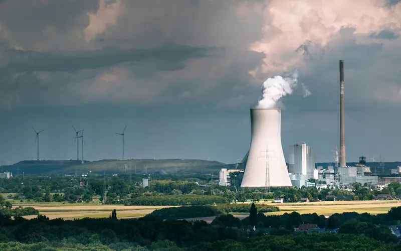 Industrial plant with a cooling tower venting steam
